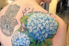 Blue hydrangea tattoo on the back and shoulder