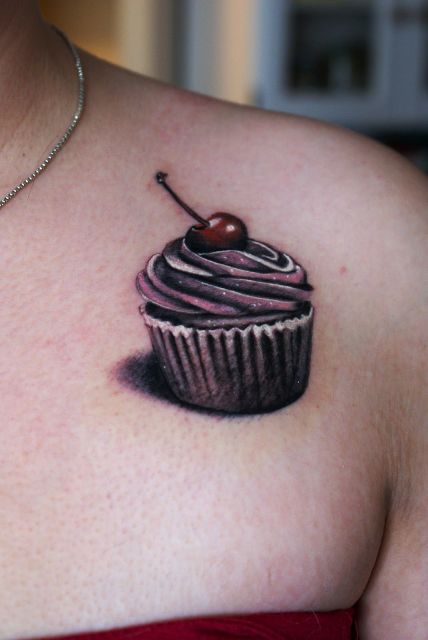 Cupcake with cherry tattoo on the shoulder