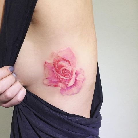 Gentle pink rose tattoo on the side