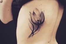 Gorgeous tulip tattoo on the side