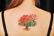 Green and orange tattoo on the back