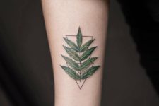 Green leaf tattoo on the arm
