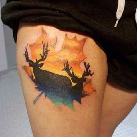 Leaf with deer image tattoo on the leg