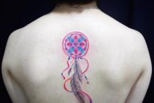Pink and blue tattoo on the back
