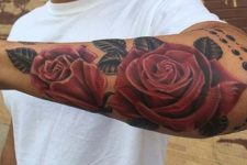 Red roses tattoo on the forearm