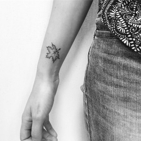 Small leaf tattoo on the forearm