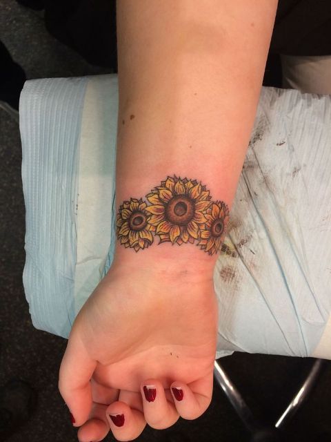 Three sunflowers tattoo on the wrist