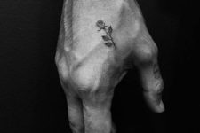 Tiny rose tattoo on the hand