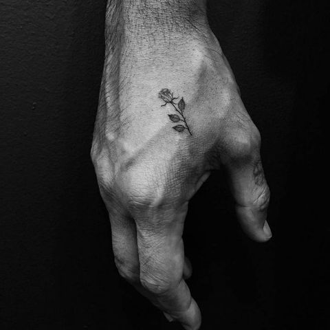Tiny rose tattoo on the hand
