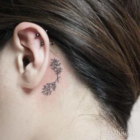 Tiny tattoo behind the ear