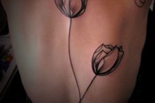 Two black tulip tattoos on the back
