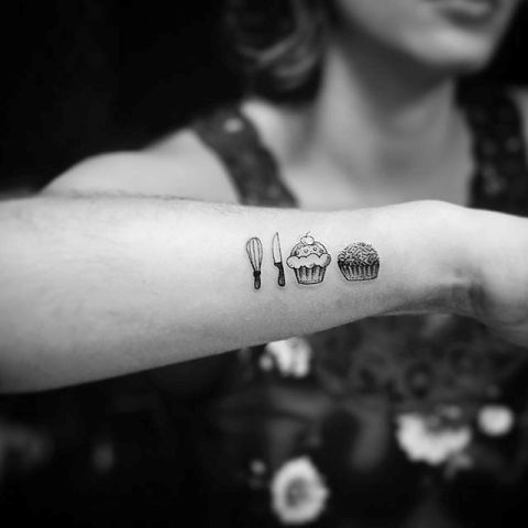 Two cupcake tattoos on the arm