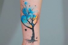 Watercolor tree tattoo on the forearm