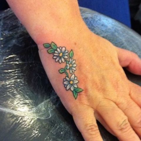 White and green daisy tattoo idea