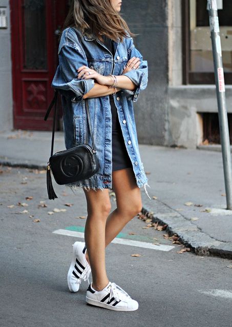 With black mini dress, black leather bag and sneakers