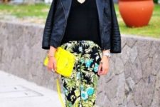 With black top, leather jacket, yellow clutch and black shoes