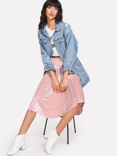 With printed t-shirt, pale pink pleated skirt and white boots