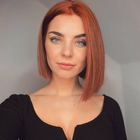 a lovely ginger red asymmetrical bob with messy parting is a cool and catchy idea to rock