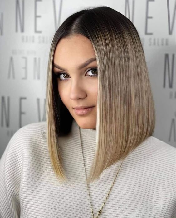 an elegant asymmetrical long bob with bold blonde balauage and slightly curled ends is a cool and catchy idea to try