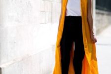 04 a white tee, black pants and shoes plus a yellow duster vest to add color