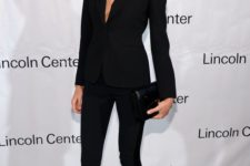 07 a black pantsuit with a plunging neckline and no top on, skinny pants
