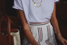 09 a white tee, a retro-inspired striped skirt with a front slit and layered necklaces