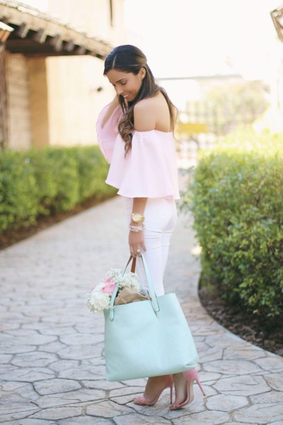 a pink off the shoulder top with long sleeves and white ripped jeans for a girlish feel