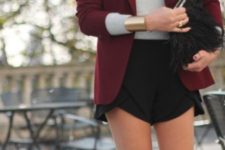 13 black asymmetrical shorts, a grey top and a burgundy jacket plus a fur bag for a party