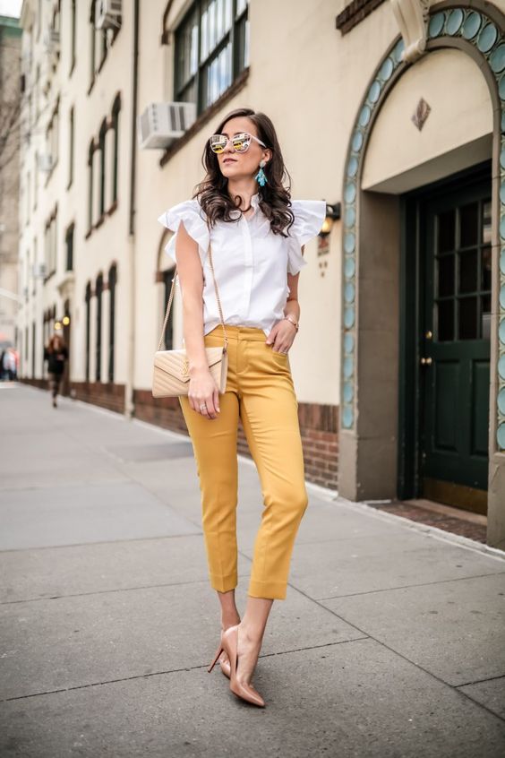 yellow cropped pants, a white blouse with ruffled sleeves, nude shoes and a neutral bag