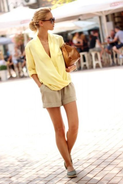 With beige shorts, brown bag and flats