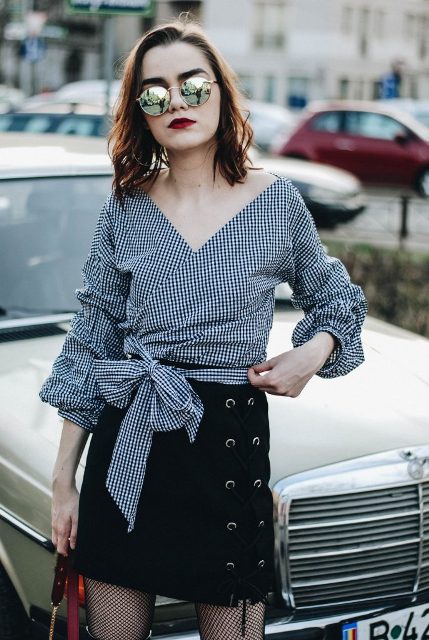 With black lace up skirt and sunglasses