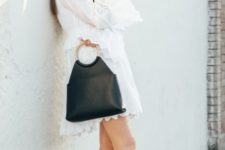 With black leather bag and white and brown flat shoes