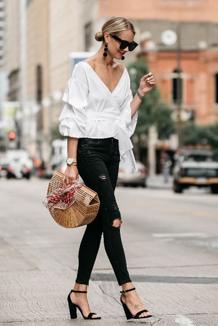 With black pants, ankle strap sandals and straw bag