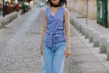 With crop jeans, blue bag and golden flat shoes