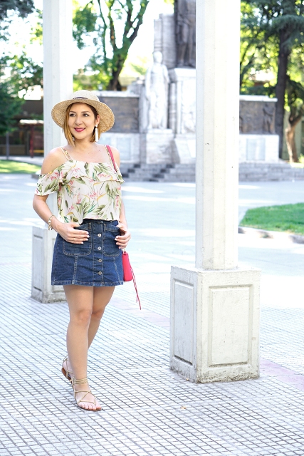 With denim skirt, lace up flat sandals, hat and red bag