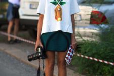 With emerald skirt, red mules and printed clutch