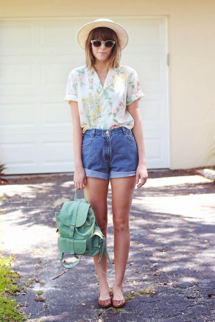 With floral shirt, hat, mint green backpack and flats