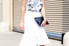 With floral top, white skirt and black clutch