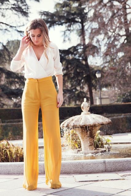 With high-waisted trousers and heels