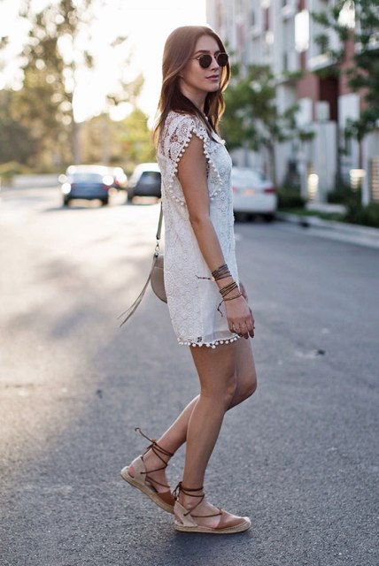 With white lace dress and beige bag