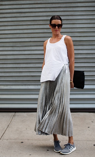 With white long top, gray sneakers and black clutch