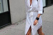 With white shirtdress and black backpack