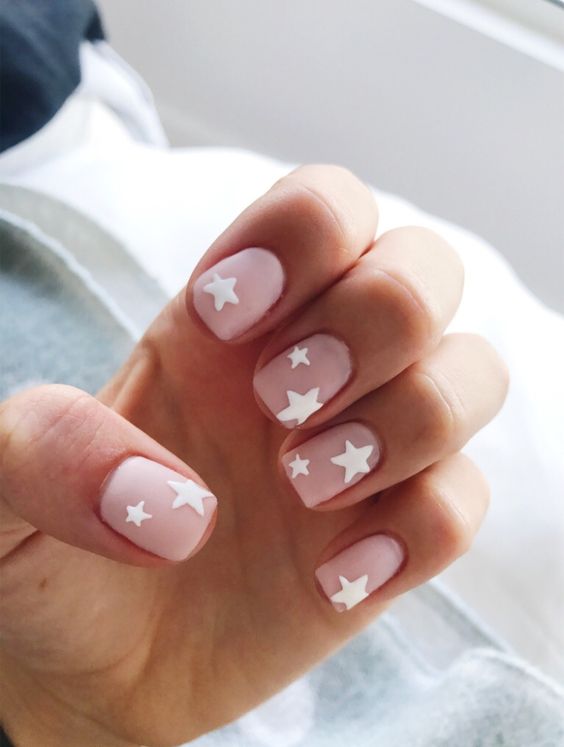 matte nude nails with white stars for a statement