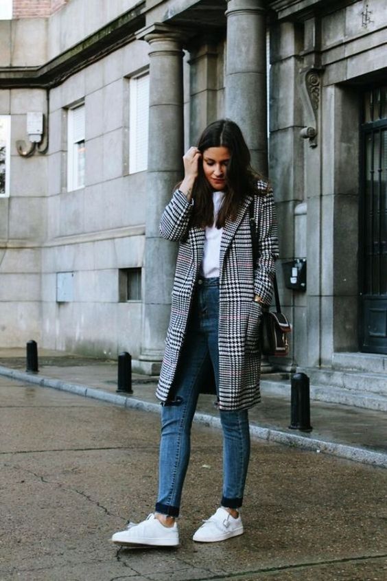 a white tee, blue jeans, white sneakers and a plaid coat for a stylish and trendy look