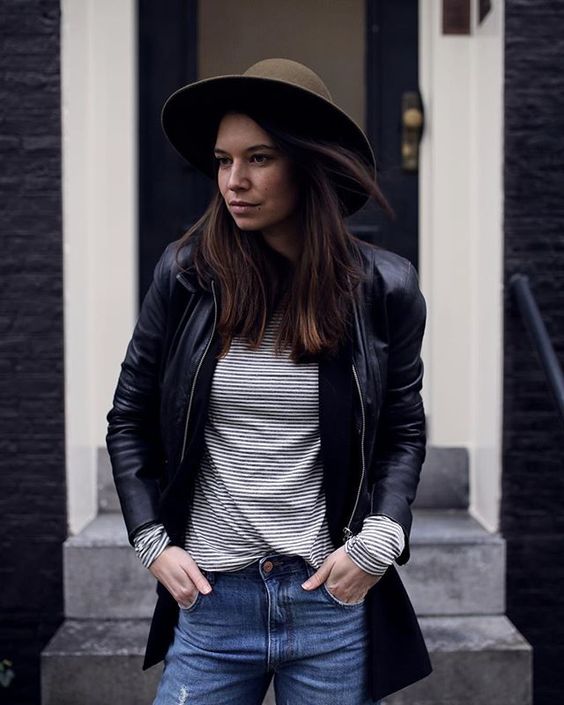 blue jeans, a striped top, a black leather jacket, an olive green hat