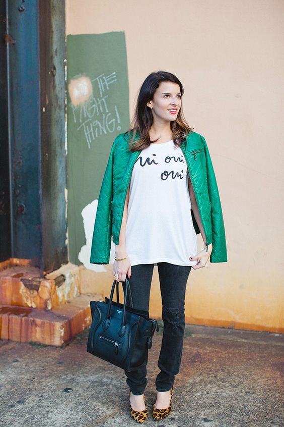 a turquoise leather jacket, black keans, an oversized printed tee, leopard shoes and a black bag