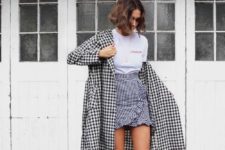11 a white logo tee, a checked ruffle wrap skirt, a checked coat and red sock boots