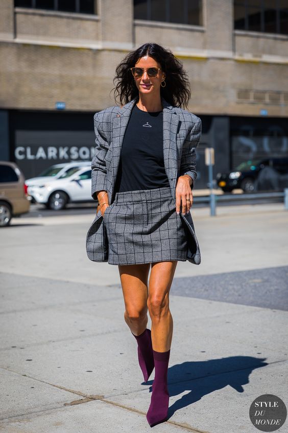 a grey checked suit with a mini skirt and an oversized blazer, a black tee and fuchsia sock boots