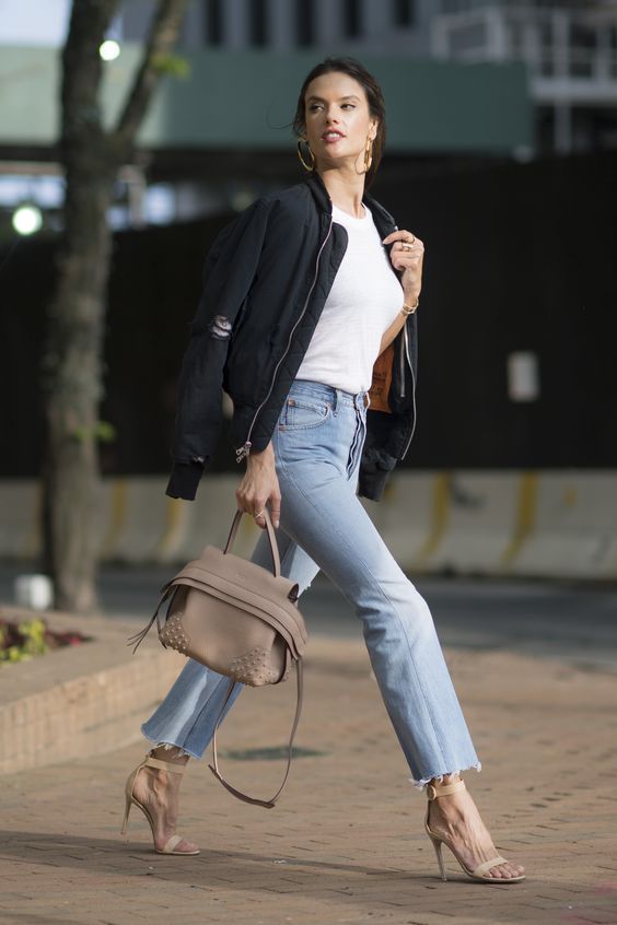 a white tee, blue jeans with a raw hem, nude shoes and a black bomber jacket