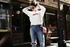 15 a simple white sweatshirt, blue ripped denim, white sneakers and a red bag